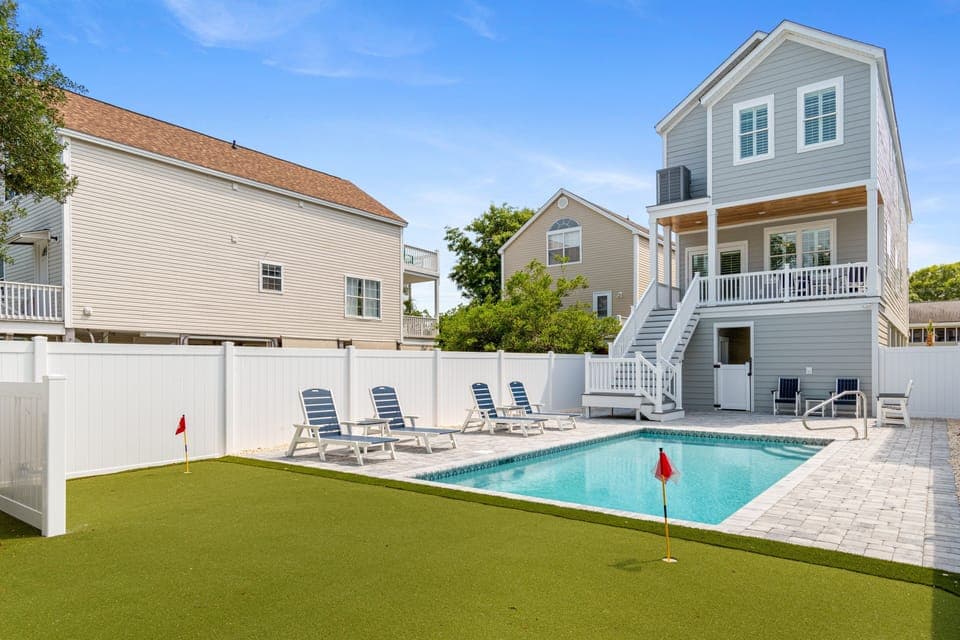 Modern coastal home featuring private pool, putting green, and spacious outdoor entertaining area perfect for group getaways.