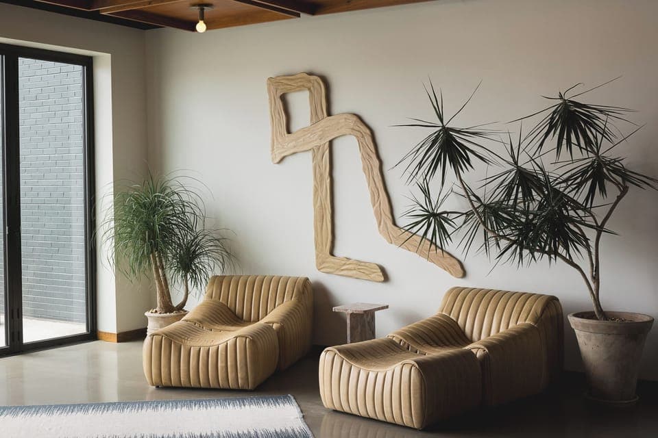 Relax into sculptural seating surrounded by calm greenery and light.