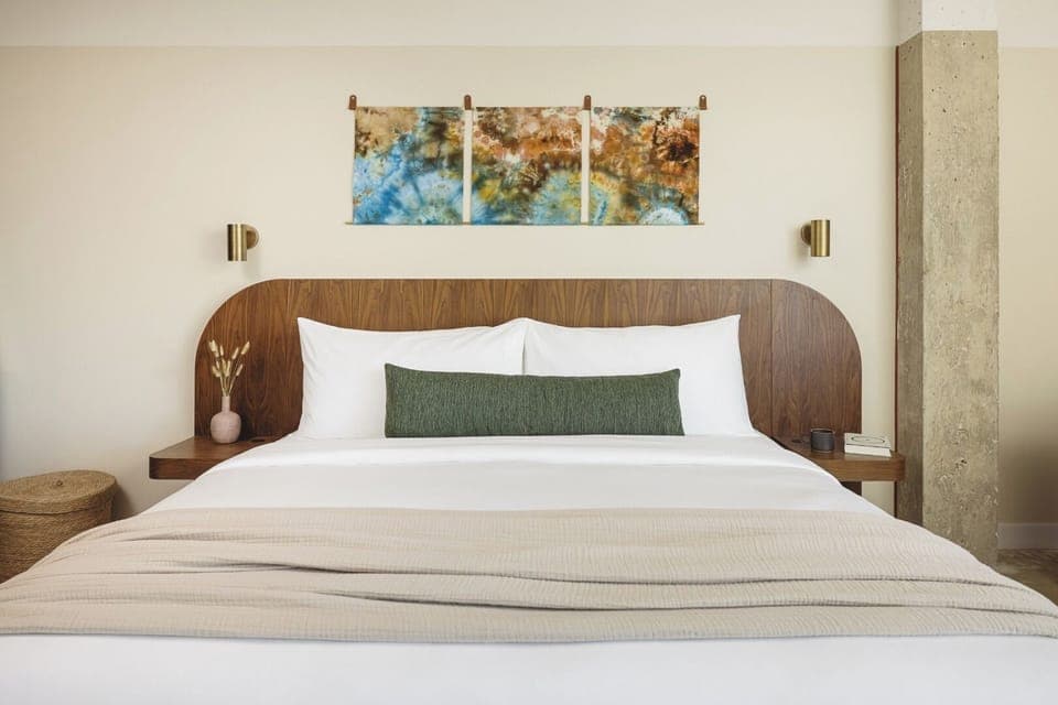 Drift off beneath warm wood tones and calming art.