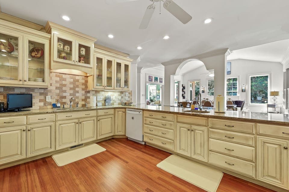 Double sinks and tons of cabinet space well-stocked for all your meal prep needs