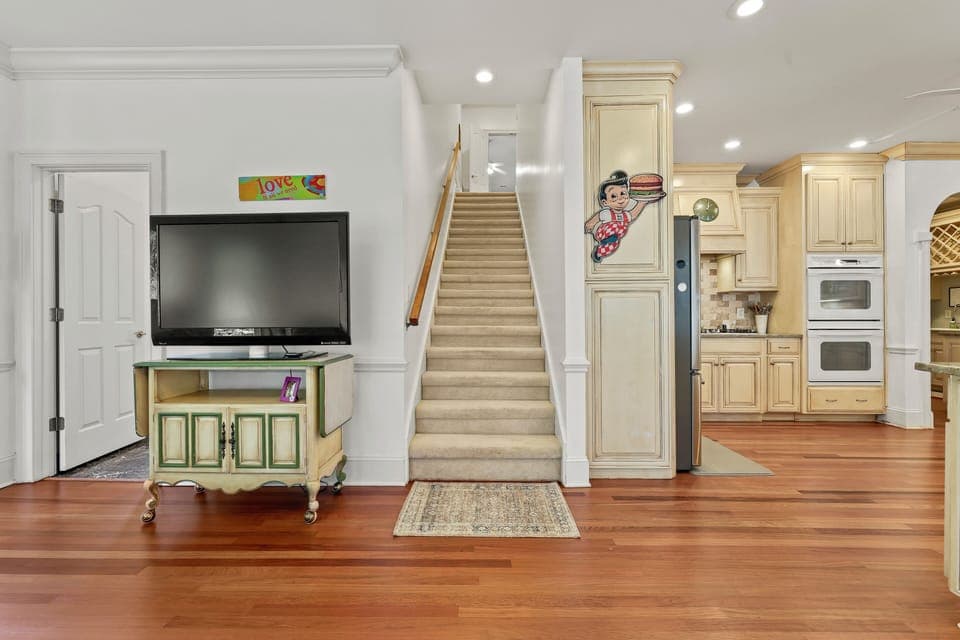 Lounge TV and back stairs.