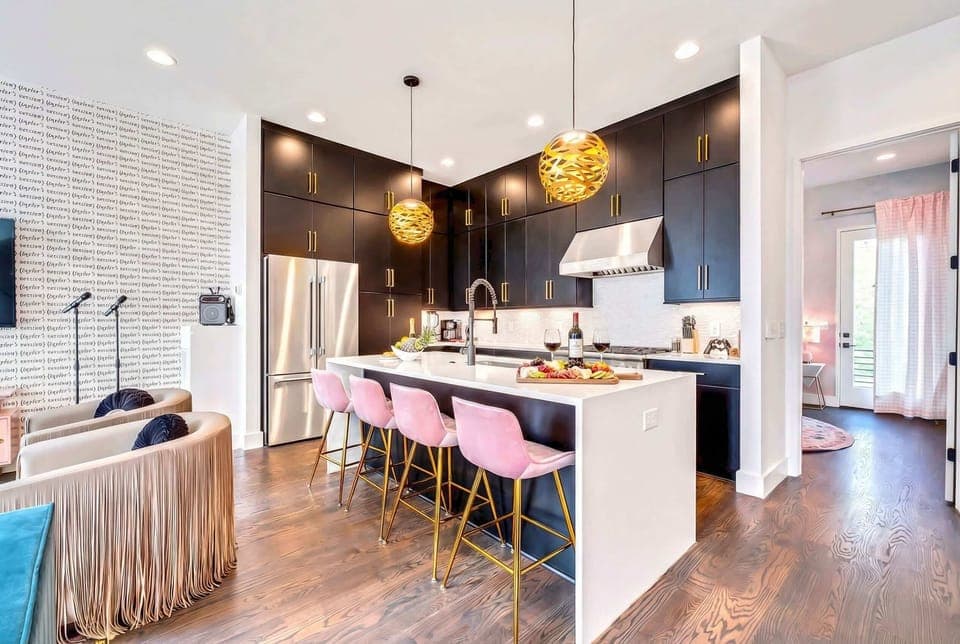 Step into chic elegance with this stunning kitchen featuring modern decor and a perfect island for gathering. Ideal for a Nashville getaway, it's a great choice for Nashville Luxury Group Accommodations. Book now with Misfit Homes and make memories!