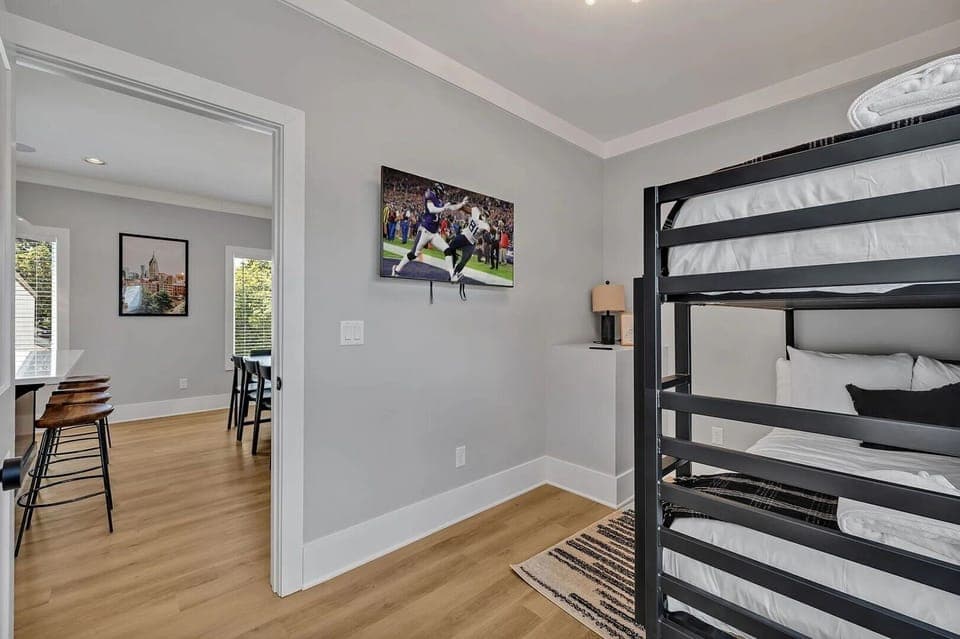 (Unit 1) 2nd Floor: 4th Bedroom featuring a bunk bed offering 2 Twin-sized mattresses, a closet space and a Smart TV for entertainment.