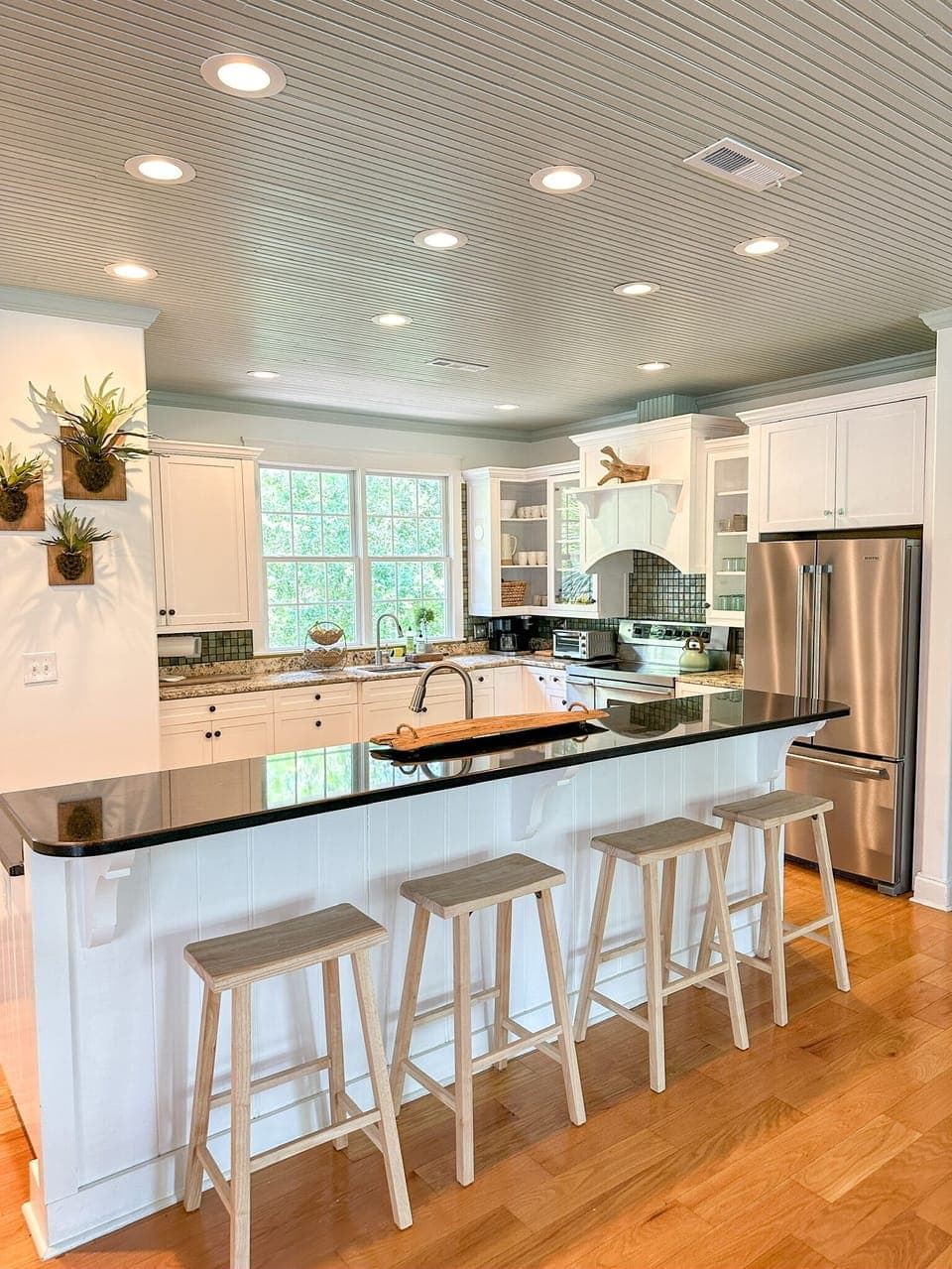 Chef kitchen with dual sinks, appliances and accessories.  Bar seating for 4