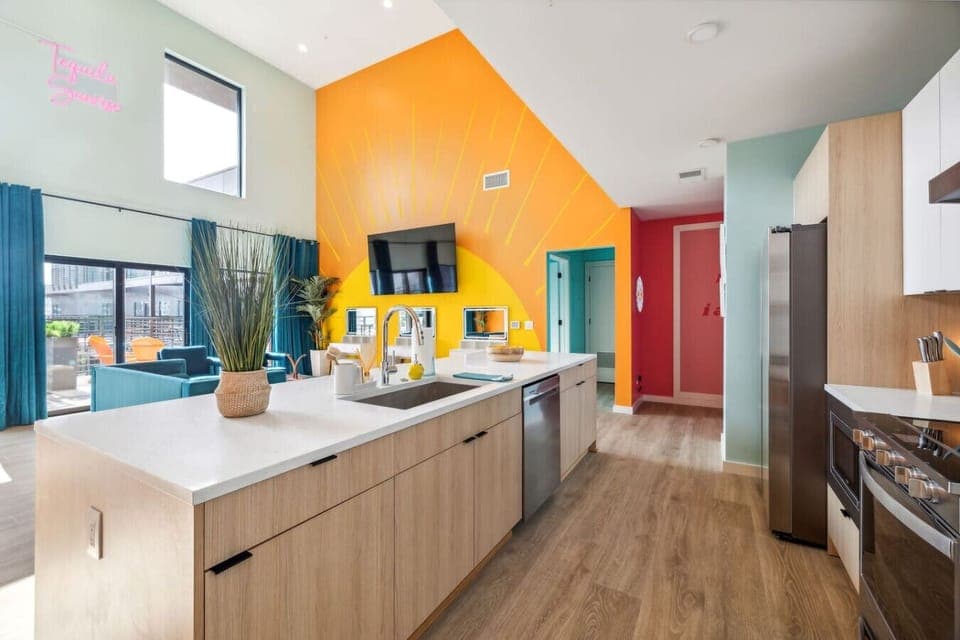 Bright, modern kitchen with plenty of counter space, full-size appliances, and an oversized island—perfect for coffee, cocktails, and gathering before a night out in Nashville.