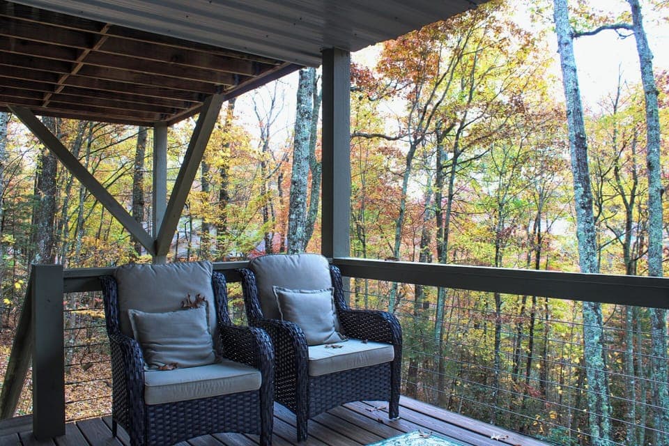 Chairs underneath balcony, near hot tub, downstairs. Stairs lead to fenced yard.