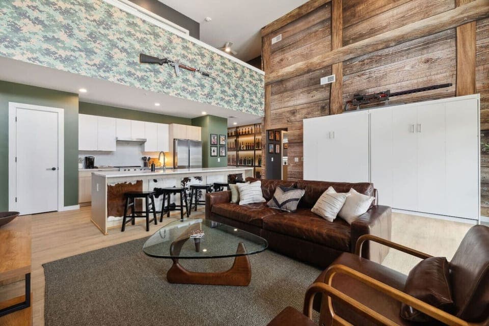 Living room with Smart TV, two queen Murphy beds, and private patio access