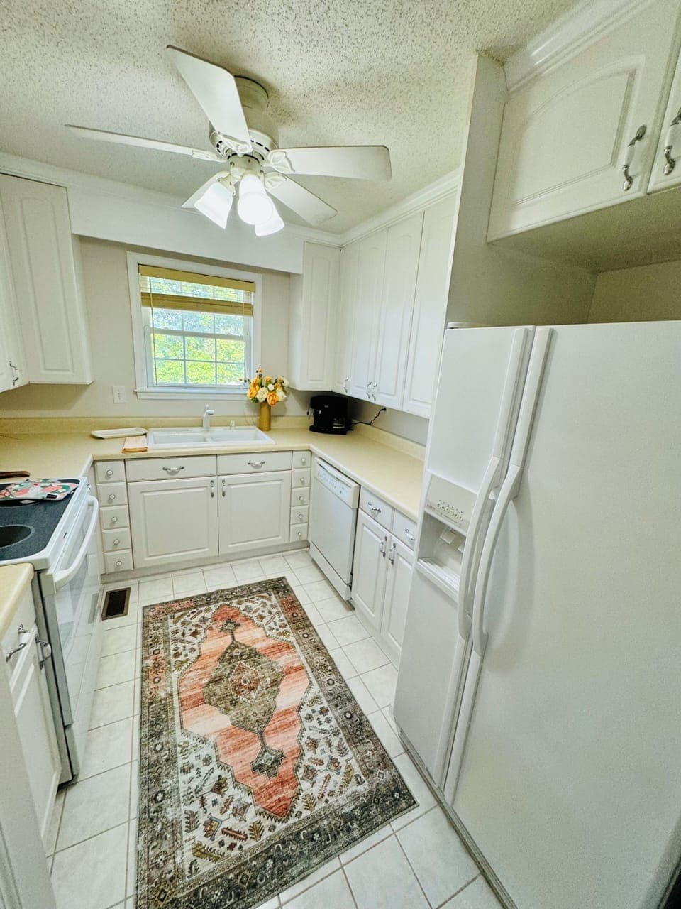 Fully equipped kitchen with generous counter space and a peaceful window view