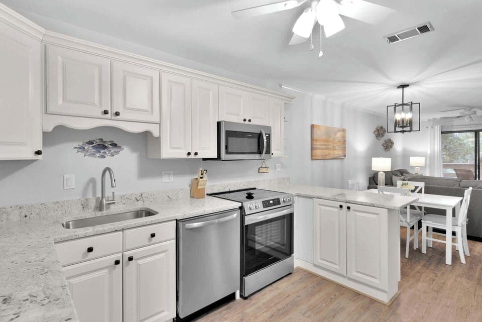 The bright, airy kitchen offers ample space & all the comforts of home
