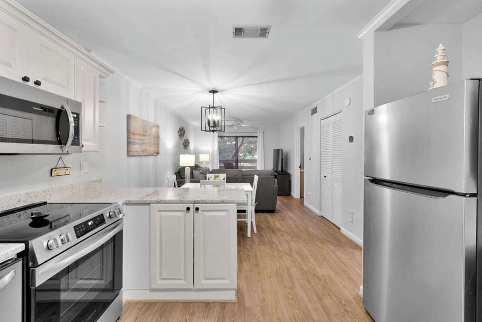 The bright, airy kitchen offers ample space & all the comforts of home