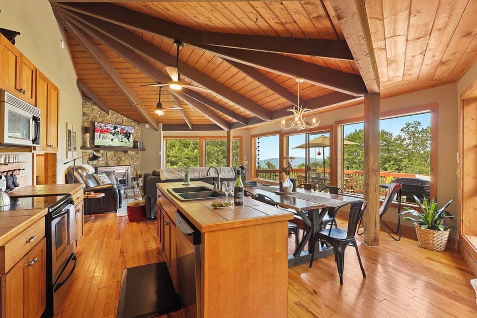Open Main Floor with Wood Floors, Exposed Beam Ceiling, Surrounded by Windows