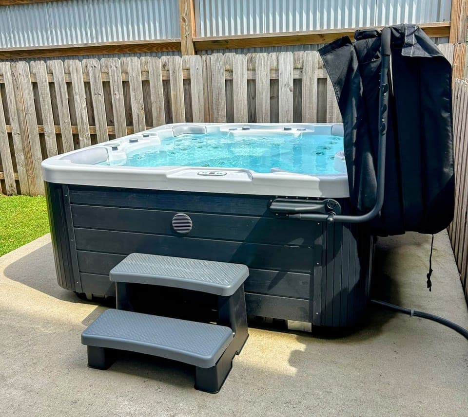 hot tub in fenced backyard