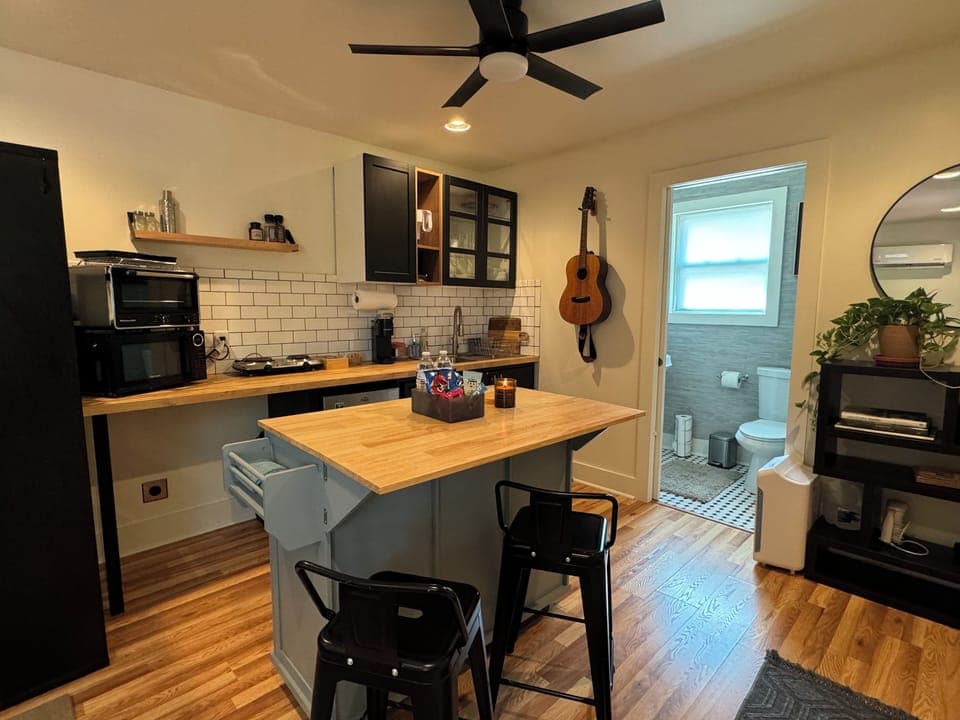 Island with seating and space to cook or work on laptop.