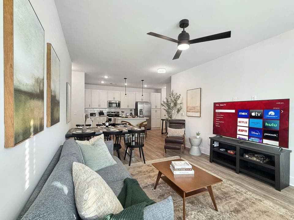 Living room with 65` Roku TV ready for you to access your favorite streaming channels from home!