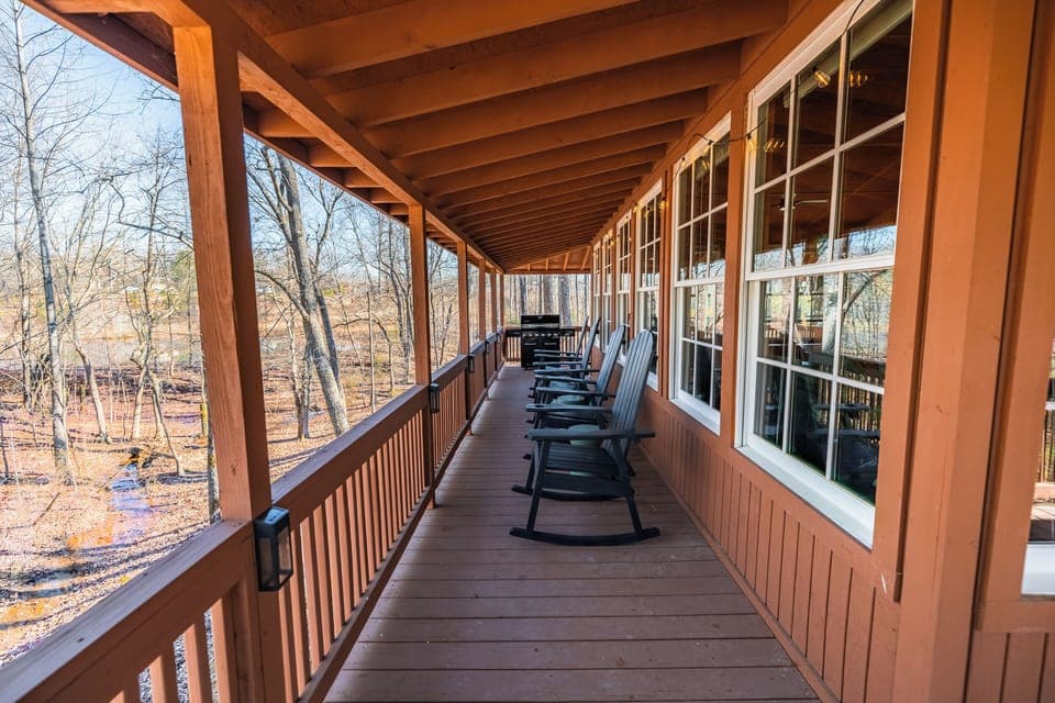 Top deck outside sunroom facing woods and a small creek.