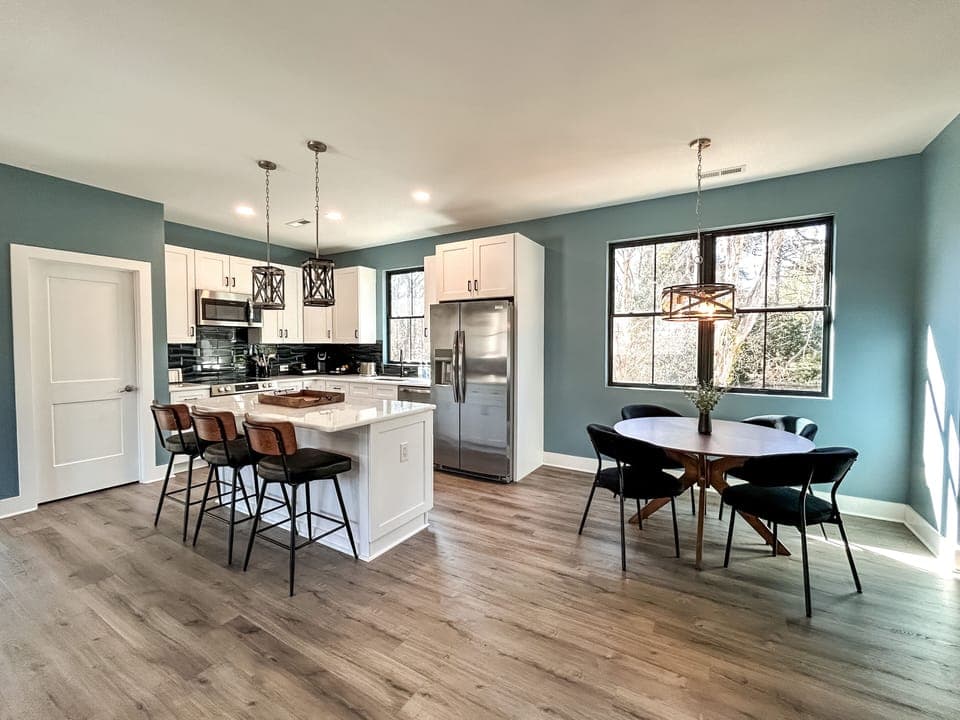 Full kitchen with modern amenities and island with seating. (1)
