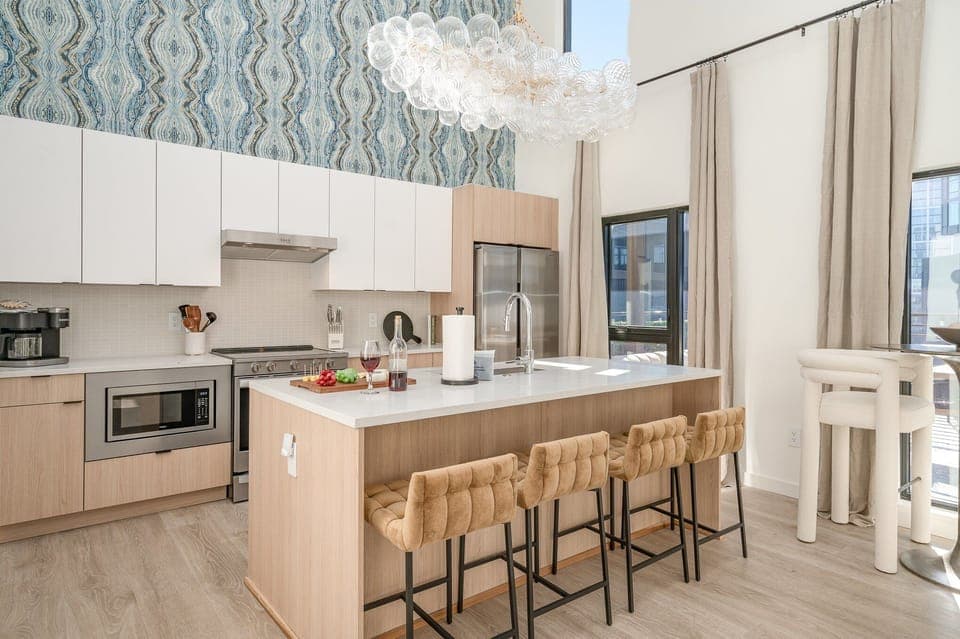 Sleek and modern, this kitchen shines with stainless steel appliances and a spacious island with bar seating for four.