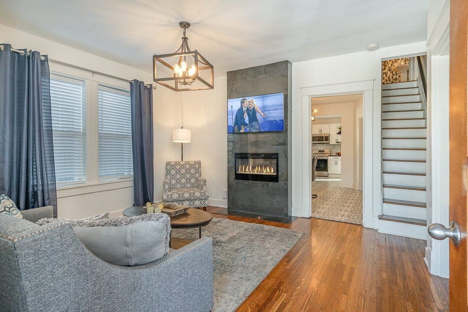 Unwind in the chic living room, featuring plush seating, a fireplace, and a Smart TV for your entertainment.
