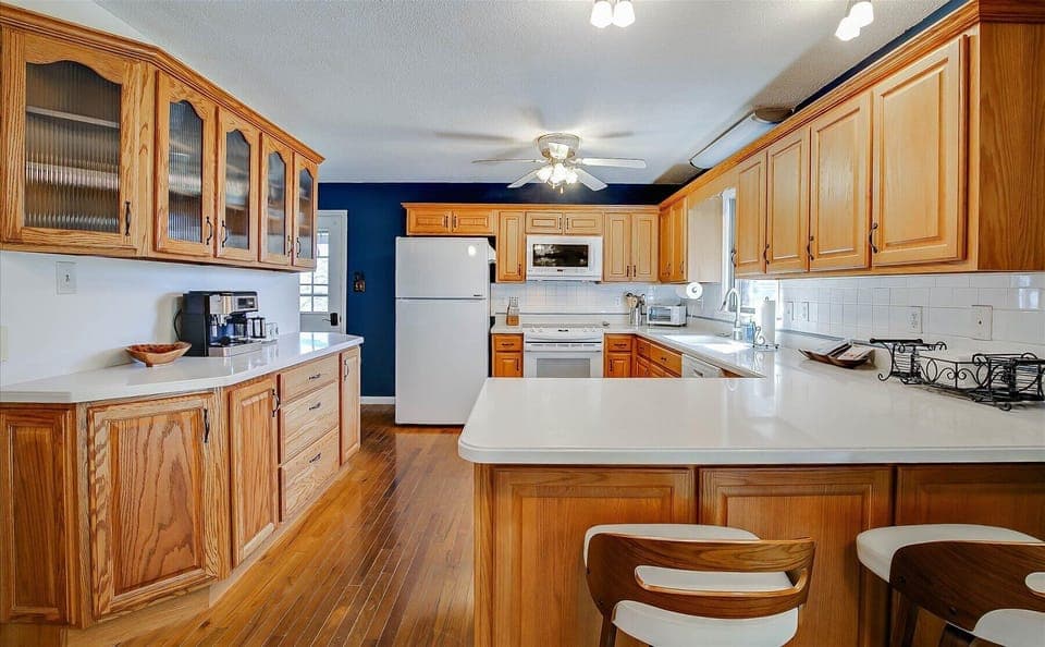 large, fully stocked kitchen with a nice counter height bar 