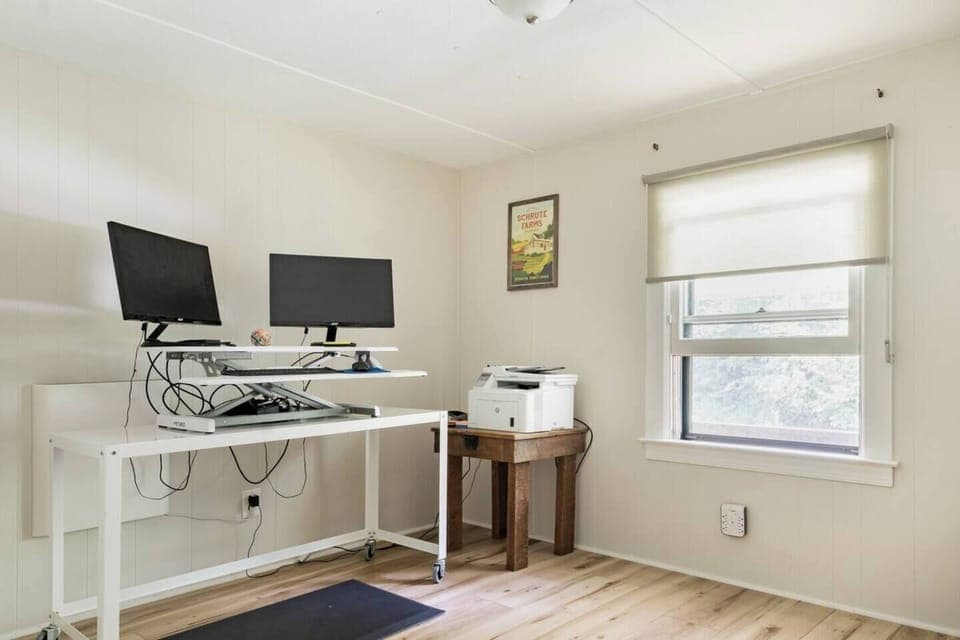 The office bedroom has a stand-up desk with WIFI printer.