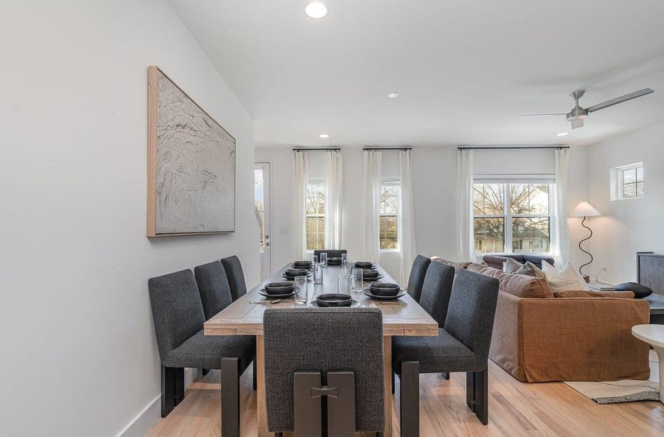 Gather around the spacious dining table for meals and conversation, creating lasting memories in this welcoming space.