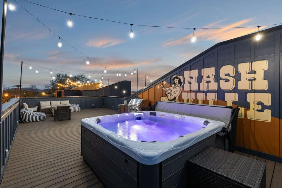 Enjoy the skyline from this stunning rooftop deck with a hot tub and chic seating—perfect for a bachelorette party or family reunion. Unwind under twinkling lights in this Nashville oasis! Your luxe getaway awaits!