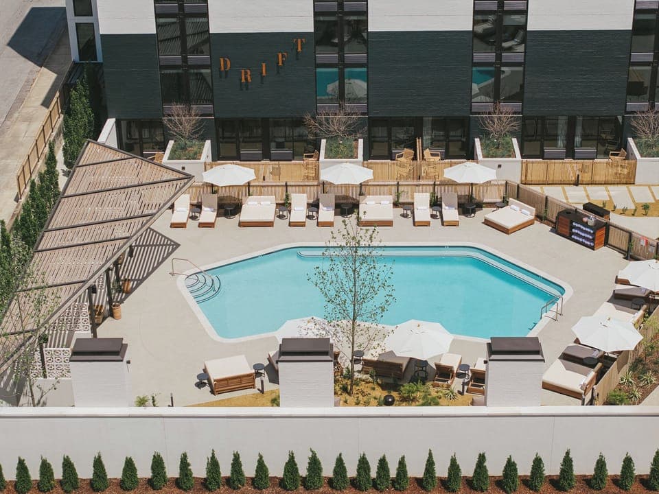Survey the serene courtyard pool designed for all-day lounging.