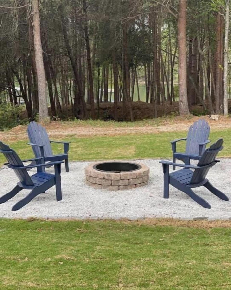 Fire pit located in the back yard with a view of the lake. 