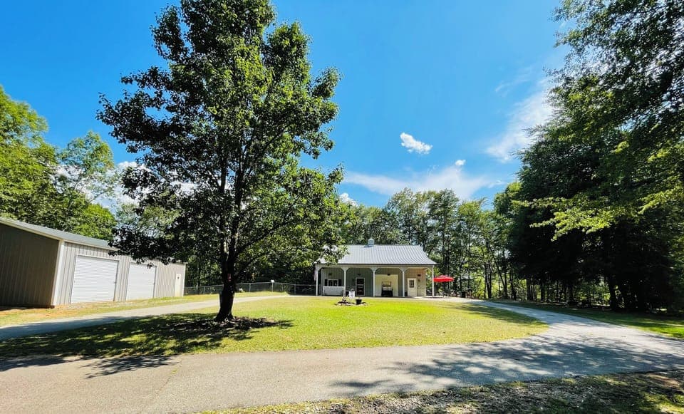 The front of the house with circle driveway. Locked storage building on left. 