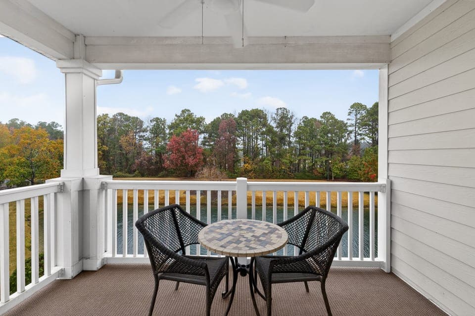 Shaded outdoor seating area with water views—great for dining or relaxing outdoors.