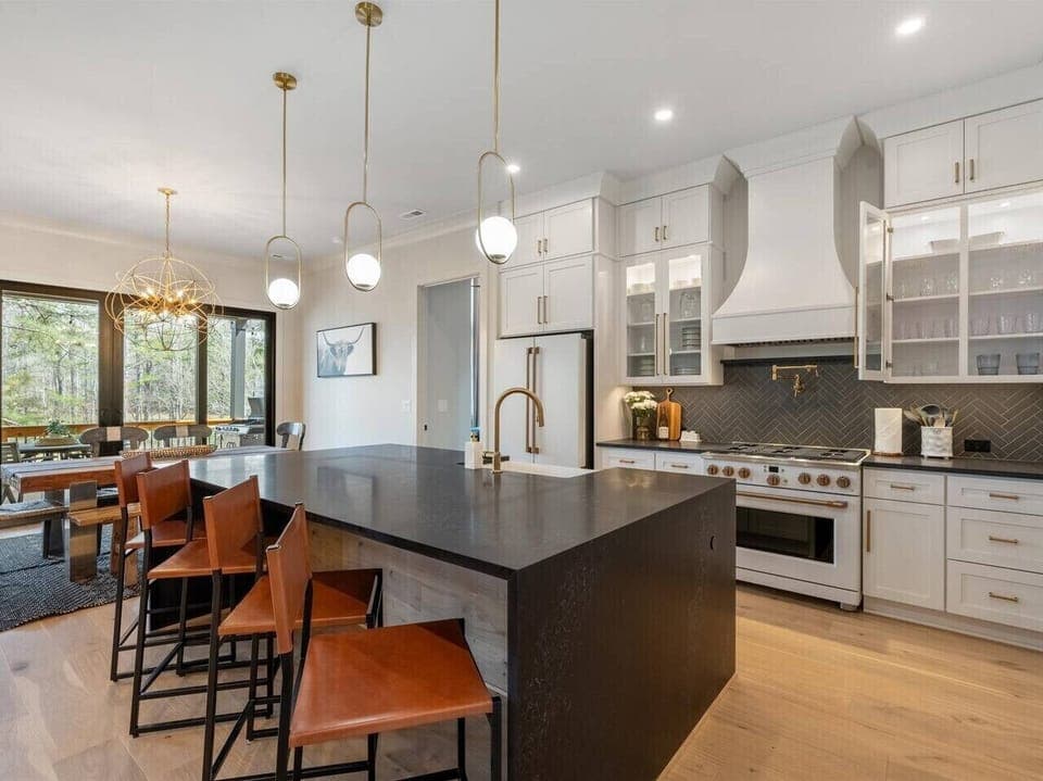 Gourmet space with sleek high-end appliances and a stylish island perfect for culinary adventures!