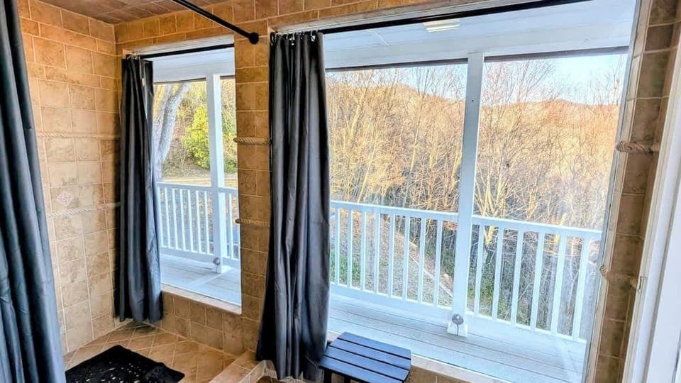 Master "Outdoor" shower!! Feels like you are outside with huge picture windows but it is enclosed for comfort. You can leave curtains open for "outdoor" feel or close them for privacy. Shower has multiple settings including jets and rain shower.