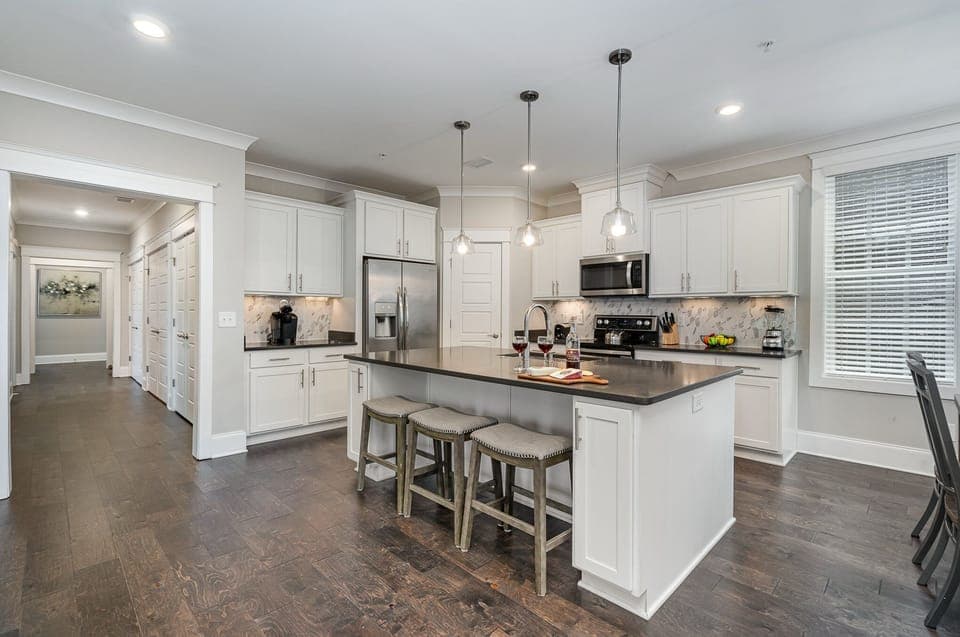 Unit 2 (2nd Floor): Fully equipped kitchen stocked with all culinary essentials, stainless steel appliances and an island offering bar seating for 3 guests.