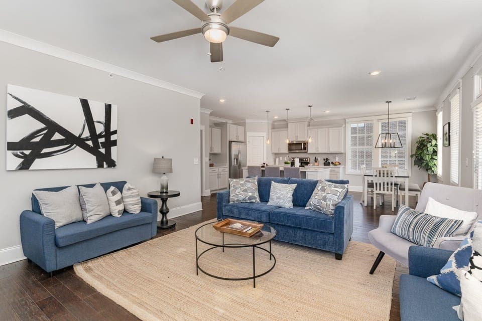 Unit 2: An open and inviting living space featuring a Smart TV and cozy furnishings, including 1 Queen sleeper sofa and 2 Twin sleeper sofas. Access to private balcony.