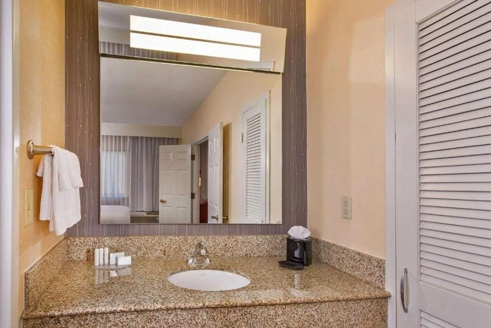 Refresh at a wide vanity with bright, flattering lighting.