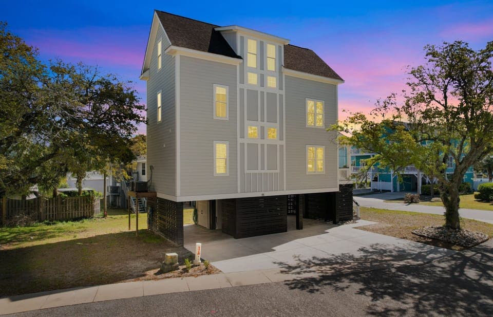 Modern coastal home with stunning twilight views in a peaceful neighborhood setting.