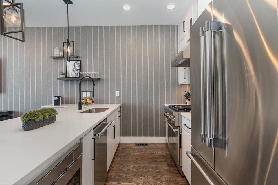 2nd Floor: Fully equipped kitchen with stainless steel appliances and a kitchen island with seating for 4 guests.