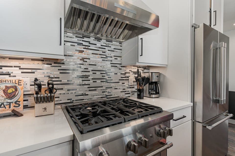2nd Floor: Fully equipped kitchen with stainless steel appliances and a kitchen island with seating for 4 guests.