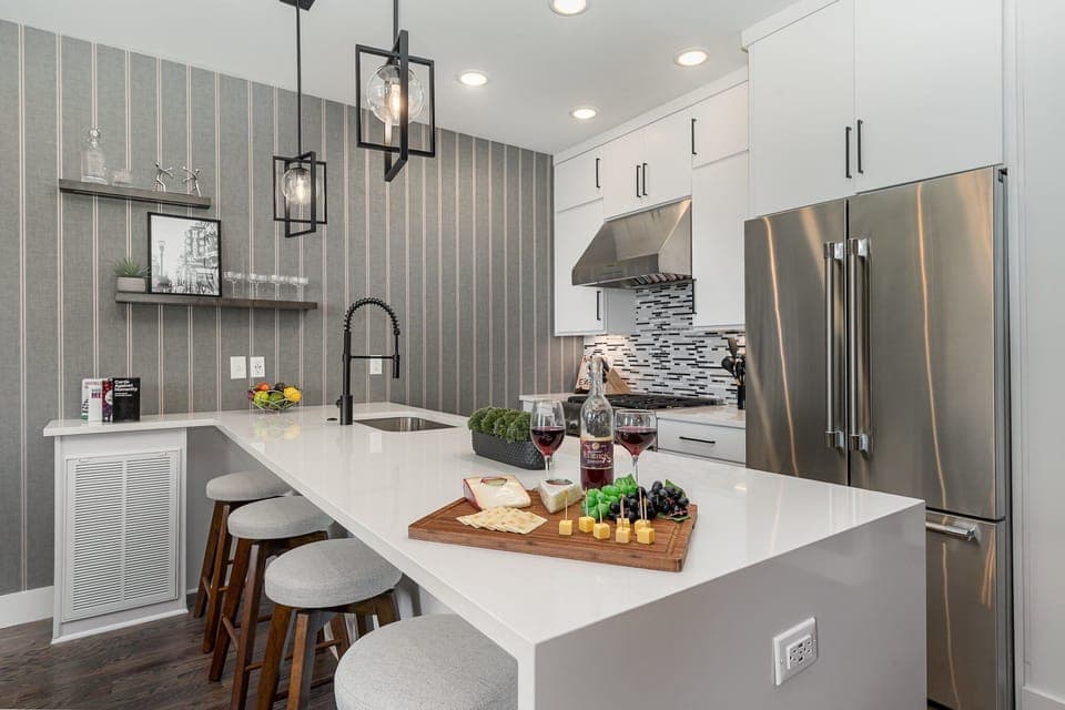 2nd Floor: Fully equipped kitchen with stainless steel appliances and a kitchen island with seating for 4 guests.