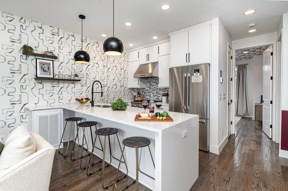 Unit 1: Fully equipped kitchen with stainless steel appliances and a kitchen island with seating for 4 guests. (2nd Floor)