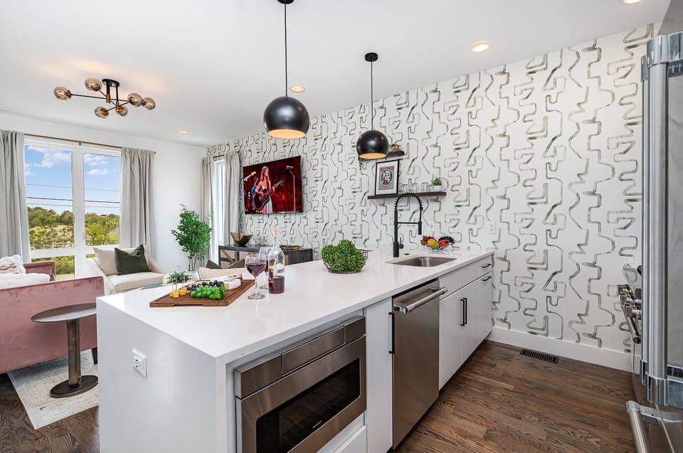 Unit 1: Fully equipped kitchen with stainless steel appliances and a kitchen island with seating for 4 guests. (2nd Floor)