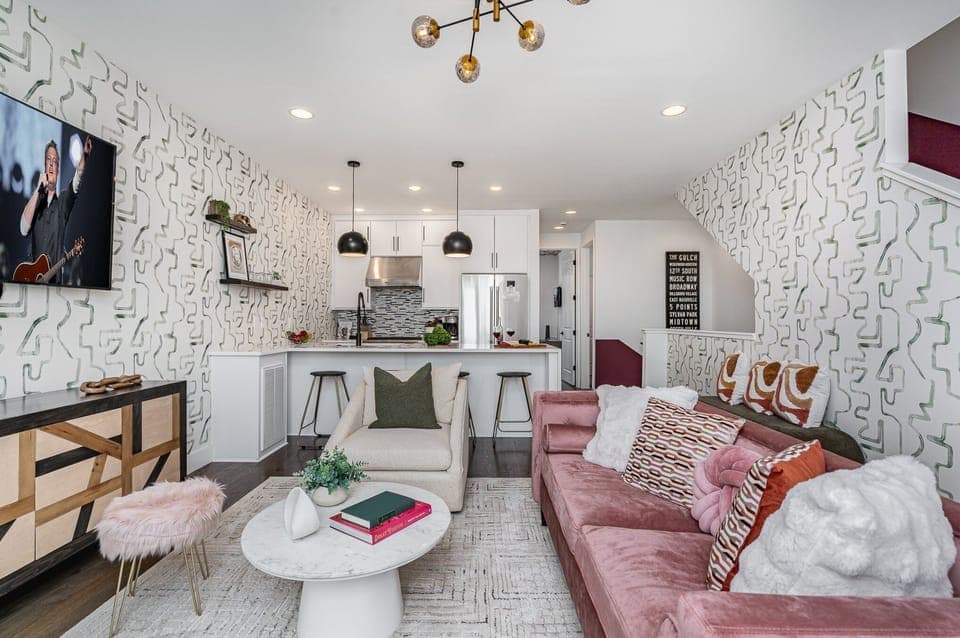 Unit 1: Open-floor living space featuring a smart TV and designer furnishings. (2nd Floor)
