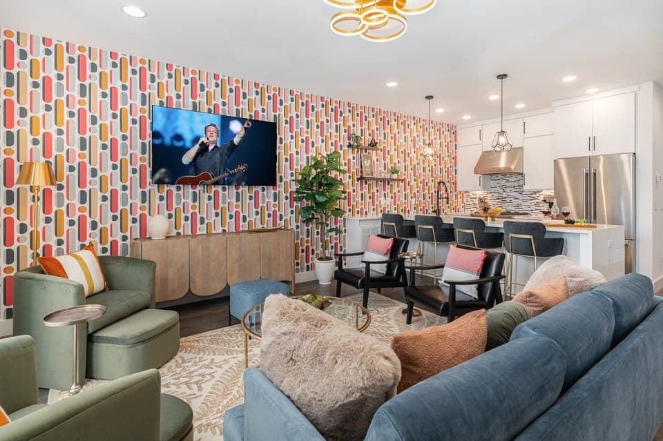 Unit 2 (2nd Floor): Bright and colorful open-concept living area featuring a Smart TV and stylish furnishings.
