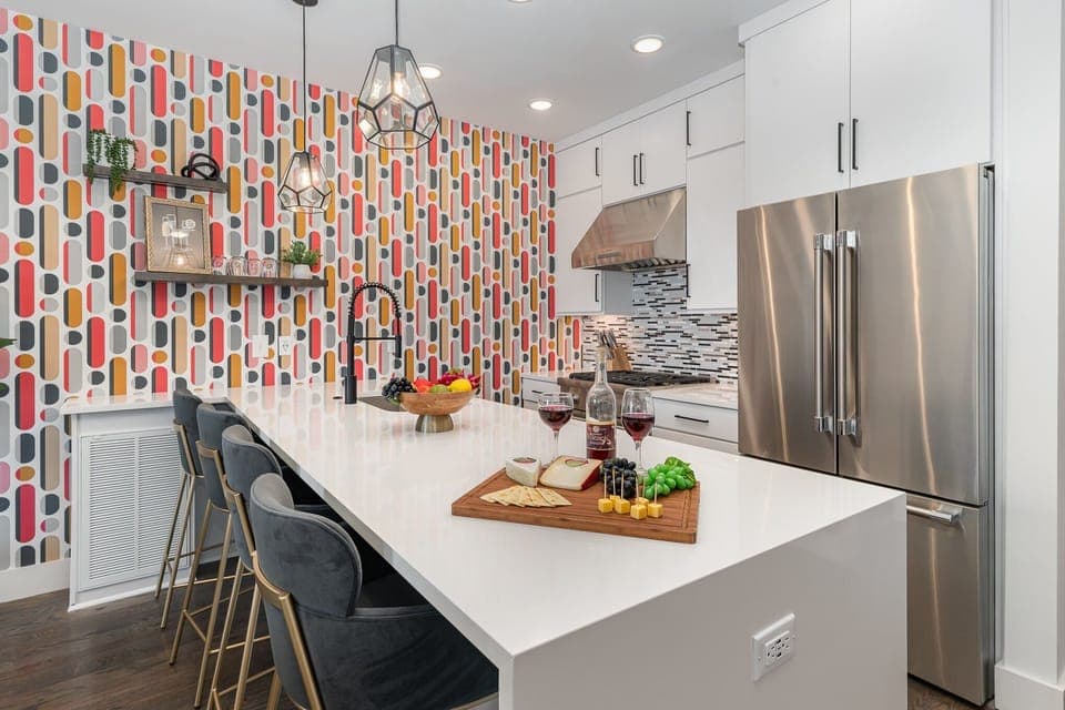 Unit 2 (2nd Floor): Fully equipped kitchen with stainless steel appliances and a kitchen island with seating for 4 guests.