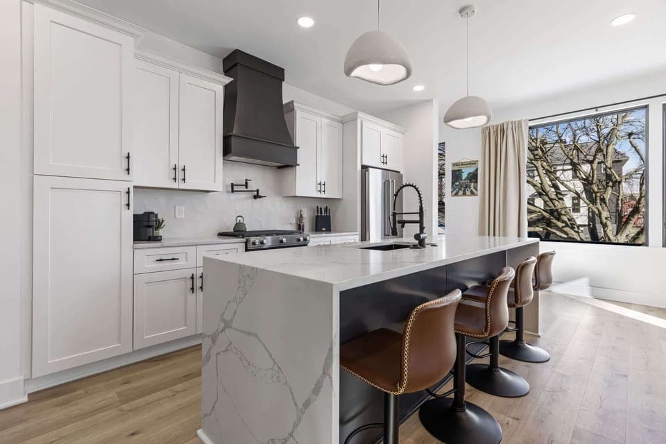 Welcome to this chic Nashville kitchen, where modern elegance meets charm. Perfect for gatherings, enjoy coffee at the island or prepare a feast. This luxurious vacation rental is ideal for your bachelorette party or family reunion, with stunning downtown views. Embrace the upscale vibe!