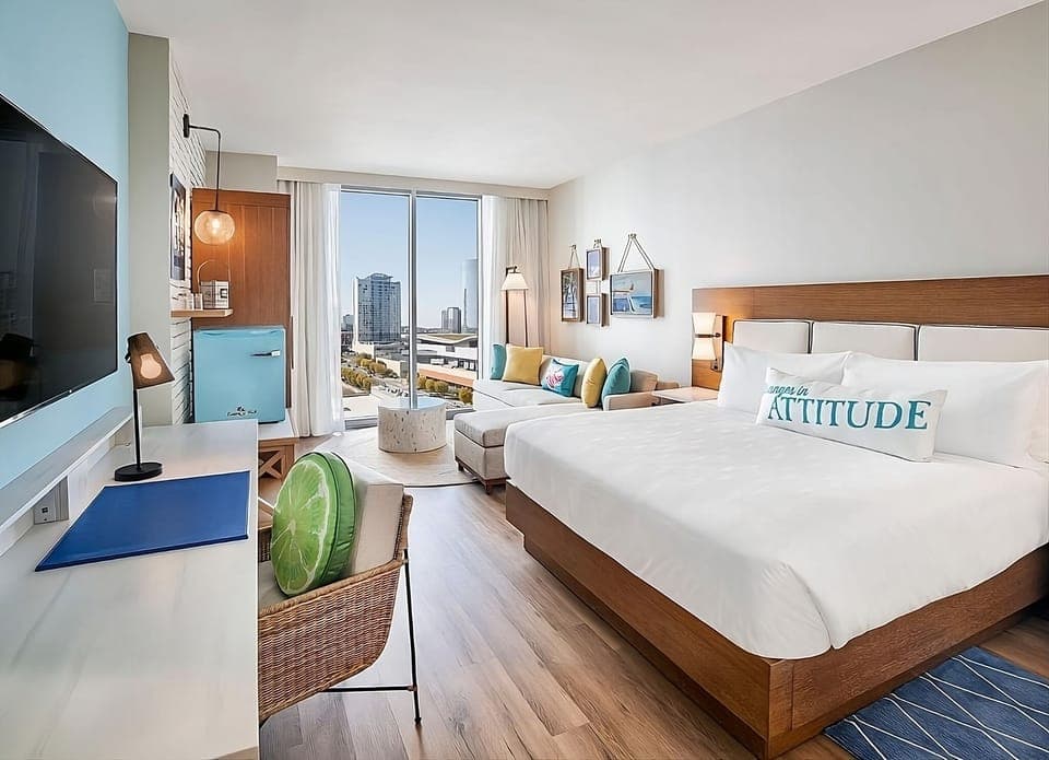 Unwind in a sunlit king room with skyline views.