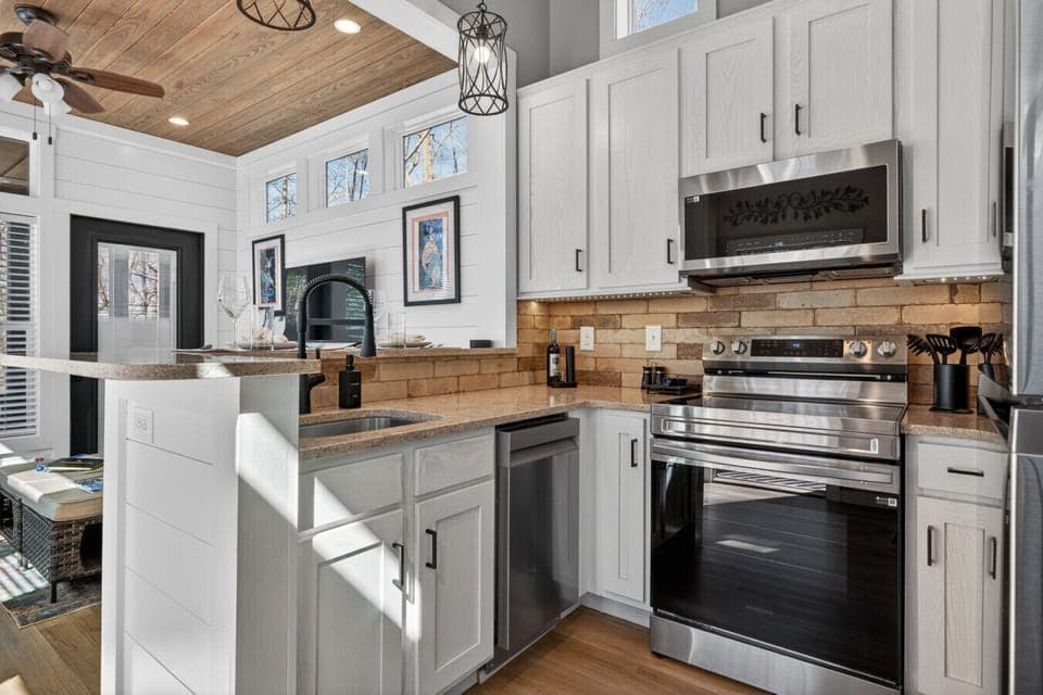 Blairsville tiny home with full kitchen, stainless appliances, coffee bar, and stocked cookware—perfect after hiking North Georgia trails and waterfalls.
