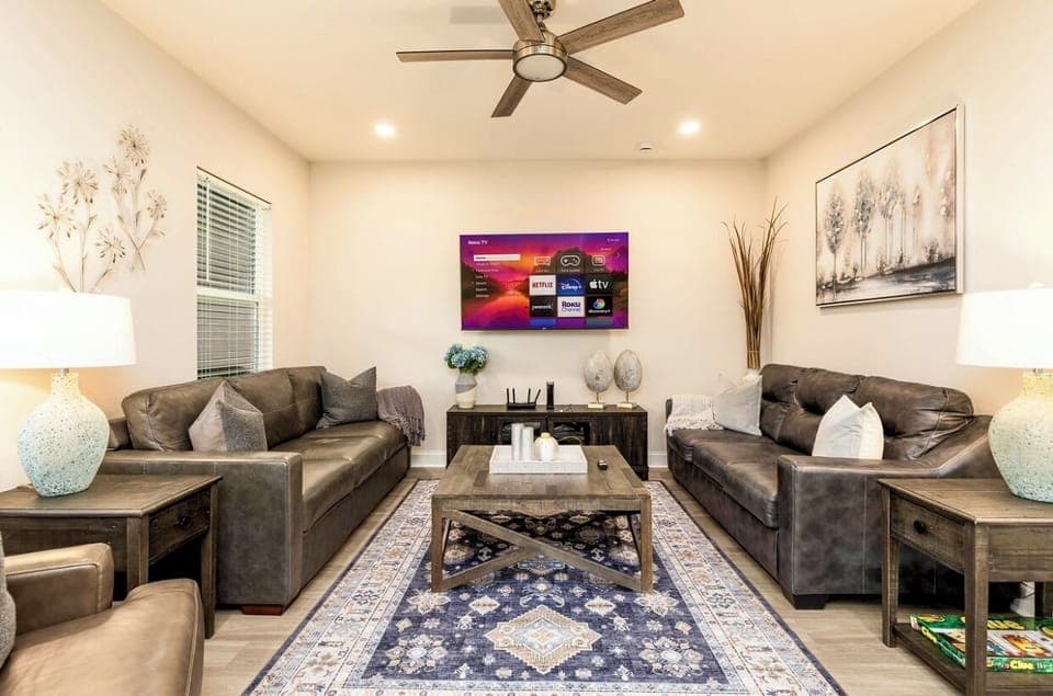 Living room with leather couches(one turns into queen bed) smart 65 inches TV