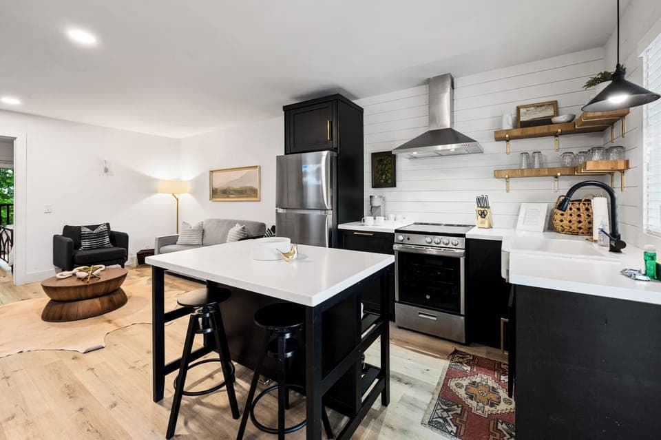 Stylish kitchen with breakfast bar and stainless steel appliances.
