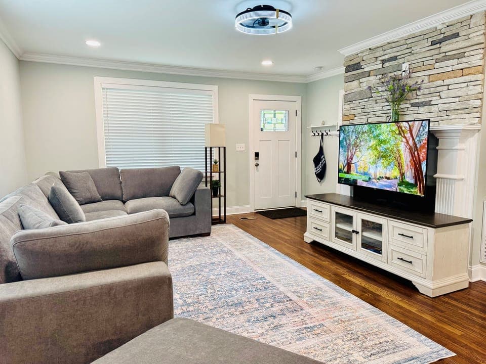 Living room with large sectional and 55in Smart TV. 